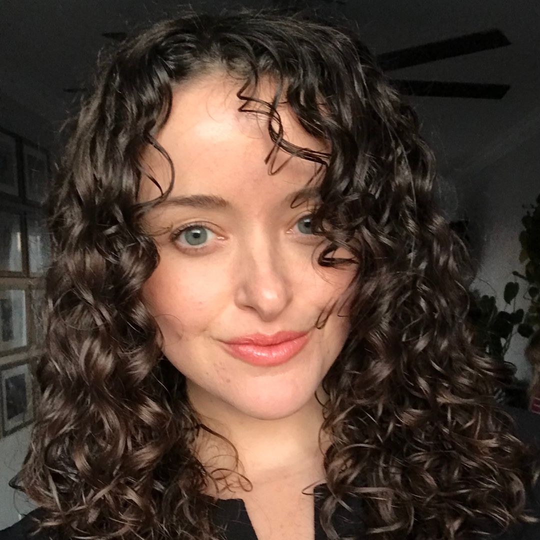 Woman with defined, healthy curls using Loba Mane's Styling Cream. Loba Mane's Styling Cream is created with all-natural organic ingredients and is made with love here in Pennsylvania.